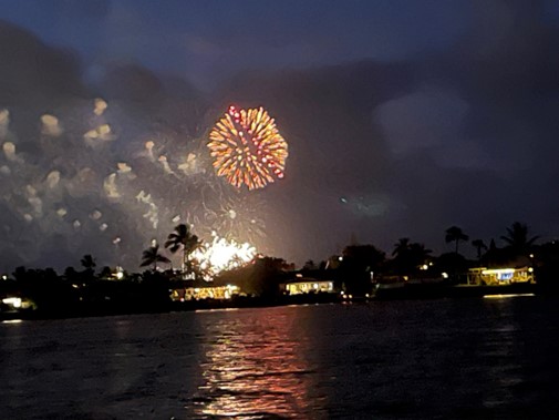 Fireworks are reflected in  the lake.
